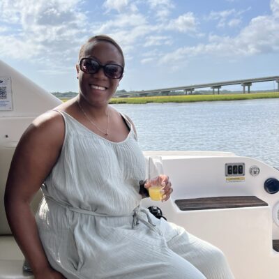 woman having a drink on a luxury yacht charter in charleston sc